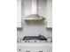 Close-up of a modern gas cooktop with sleek stainless steel range hood and granite countertops at 383 Mikita Dr., Surfside Beach, SC 29575