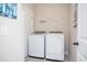 Functional laundry room furnished with a modern washer and dryer, complemented by wall decor at 383 Mikita Dr., Surfside Beach, SC 29575