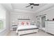 Spacious main bedroom with a tray ceiling, king bed, and barn door to the bathroom at 383 Mikita Dr., Surfside Beach, SC 29575
