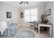 Well-lit office space featuring a patterned chair, a ceiling fan, a desk, and a bright window at 383 Mikita Dr., Surfside Beach, SC 29575