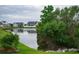 Scenic view of a tranquil pond surrounded by lush greenery and waterfront homes at 383 Mikita Dr., Surfside Beach, SC 29575