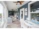 Cozy sunroom with coastal decor, featuring a dining area and a comfortable seating arrangement at 383 Mikita Dr., Surfside Beach, SC 29575