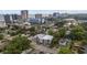 An aerial view shows buildings amidst lush greenery, with the ocean and skyline visible in the distance at 403 14Th Ave. S, Myrtle Beach, SC 29572