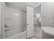 White bathroom with shower and tub combo, and a view into another room at 403 14Th Ave. S, Myrtle Beach, SC 29572