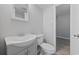 Small bathroom featuring a white vanity, toilet, and a doorway leading to another room at 403 14Th Ave. S, Myrtle Beach, SC 29572