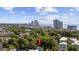 Aerial view showcases the home's location amongst mature trees with the city skyline in the distance at 409 2Nd Ave. S, Myrtle Beach, SC 29577