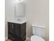 Bathroom vanity with an illuminated mirror, toilet at 409 2Nd Ave. S, Myrtle Beach, SC 29577