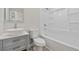 Well-lit bathroom with a vessel sink, modern vanity, toilet, and a combined tub and shower at 409 2Nd Ave. S, Myrtle Beach, SC 29577