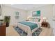Bedroom with a bed, nightstands, and a window, decorated with neutral and teal tones at 409 2Nd Ave. S, Myrtle Beach, SC 29577