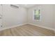 Bright bedroom with light wood floors, neutral walls, and window providing natural light at 409 2Nd Ave. S, Myrtle Beach, SC 29577