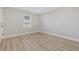 Bright bedroom with light wood floors, neutral walls, and window providing natural light at 409 2Nd Ave. S, Myrtle Beach, SC 29577