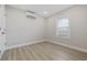 A light-filled bedroom featuring neutral walls, wood-look floors, and mini-split air conditioning at 409 2Nd Ave. S, Myrtle Beach, SC 29577
