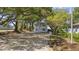 Exterior of the home surrounded by mature trees and landscape with ample space for parking at 409 2Nd Ave. S, Myrtle Beach, SC 29577