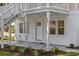 Close up of home's exterior featuring a welcoming entrance, well-maintained siding, and new landscaping at 409 2Nd Ave. S, Myrtle Beach, SC 29577