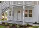 Exterior view of home with a charming entrance, complemented by lush landscaping and a well-maintained yard at 409 2Nd Ave. S, Myrtle Beach, SC 29577
