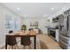 Bright kitchen and dining area featuring stainless steel appliances and a wooden dining table at 409 2Nd Ave. S, Myrtle Beach, SC 29577