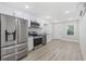 Modern kitchen features white cabinets, stainless steel appliances, and light wood floors at 409 2Nd Ave. S, Myrtle Beach, SC 29577