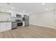 Bright kitchen features stainless steel appliances, granite countertops, and sleek white cabinetry at 409 2Nd Ave. S, Myrtle Beach, SC 29577