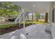 This ground level patio space features a concrete floor, white post and stair supports, and manicured landscaping at 409 2Nd Ave. S, Myrtle Beach, SC 29577