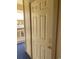 Apartment front door with gold hardware, beige trim, and blue carpet on a covered landing at 4107 Pinehurst Circle # Dd-15, Little River, SC 29566