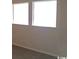 Bedroom showcasing two windows, neutral paint, and carpet at 411 Cambridge Circle # D4, Murrells Inlet, SC 29576