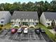 View of a quaint two-story condo building with a gray roof, light green siding, and white stairs at 411 Cambridge Circle # D4, Murrells Inlet, SC 29576