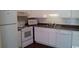 Bright kitchen featuring white appliances and cabinets, complete with modern amenities at 411 Cambridge Circle # D5, Murrells Inlet, SC 29576