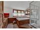 This bright bathroom features a tub, glass shower, wood accents and natural light at 4131 Gunter Lake Rd., Galivants Ferry, SC 29544
