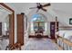 Charming bedroom features an oval window, hardwood floors, and a decorative rug at 4131 Gunter Lake Rd., Galivants Ferry, SC 29544