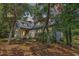 Charming two-story home nestled among trees with a metal roof and inviting front porch at 4131 Gunter Lake Rd., Galivants Ferry, SC 29544