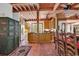Open kitchen with wooden cabinets, an island, and terracotta tile floors next to the dining room at 4131 Gunter Lake Rd., Galivants Ferry, SC 29544