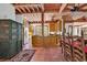 Rustic kitchen with exposed beam ceiling, terra cotta floors, and a large kitchen island at 4131 Gunter Lake Rd., Galivants Ferry, SC 29544
