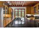Open kitchen with black countertops, stainless steel appliances, and exposed beam ceiling at 4131 Gunter Lake Rd., Galivants Ferry, SC 29544