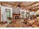 Open-concept living area with vaulted ceilings, a brick fireplace, and lots of natural light at 4131 Gunter Lake Rd., Galivants Ferry, SC 29544