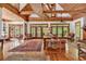 Spacious living room with brick fireplace, hardwood floors, vaulted ceilings, and multiple seating areas at 4131 Gunter Lake Rd., Galivants Ferry, SC 29544