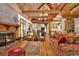 Spacious living room with exposed beams, hardwood floors, brick fireplace, and open layout at 4131 Gunter Lake Rd., Galivants Ferry, SC 29544