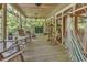 Relax on this screened porch with multiple seating options, including a hammock at 4131 Gunter Lake Rd., Galivants Ferry, SC 29544
