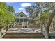 Charming rear exterior with tiered decking and direct access to nature at 4131 Gunter Lake Rd., Galivants Ferry, SC 29544