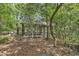 Outdoor screened porch surrounded by trees for comfortable outdoor relaxation at 4131 Gunter Lake Rd., Galivants Ferry, SC 29544