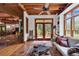 Relaxing sunroom with terracotta tile floors, access to the deck, and rustic wooden accents at 4131 Gunter Lake Rd., Galivants Ferry, SC 29544