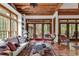 Bright sunroom with terracotta floors, large windows, and comfortable seating at 4131 Gunter Lake Rd., Galivants Ferry, SC 29544
