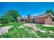 Brick home featuring a stone chimney and a spacious backyard, creating a private retreat at 4145 Highway 308, Galivants Ferry, SC 29544