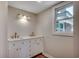 Bathroom vanity with double sinks, storage, and elegant lighting at 4145 Highway 308, Galivants Ferry, SC 29544