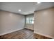 Bedroom with wood-look floors, neutral paint, and a large window at 4145 Highway 308, Galivants Ferry, SC 29544