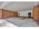 Spacious attached carport featuring exposed brick, painted drywall, and a sturdy concrete floor at 4145 Highway 308, Galivants Ferry, SC 29544