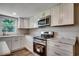 Updated kitchen featuring stainless appliances, white cabinets, marble countertops, and modern fixtures at 4145 Highway 308, Galivants Ferry, SC 29544
