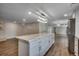 Kitchen island with marble countertop, stainless steel appliances, and white cabinets, flowing into the living area at 4145 Highway 308, Galivants Ferry, SC 29544