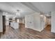 View of the kitchen with stainless appliances, white cabinetry, and a view of the living room at 4145 Highway 308, Galivants Ferry, SC 29544