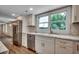 Modern kitchen with marble counters, stainless steel appliances, and white cabinets, complemented by natural light at 4145 Highway 308, Galivants Ferry, SC 29544