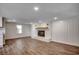 Living room featuring a white brick fireplace, wood mantel, and wainscoting, complemented by modern flooring at 4145 Highway 308, Galivants Ferry, SC 29544
